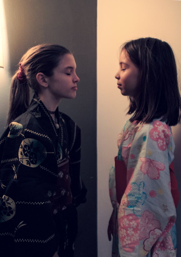 Young Girls In Kimonos Standing Face To Face