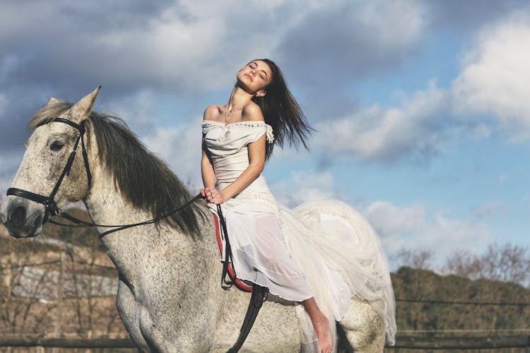 Woman In White Dress Riding White Horse