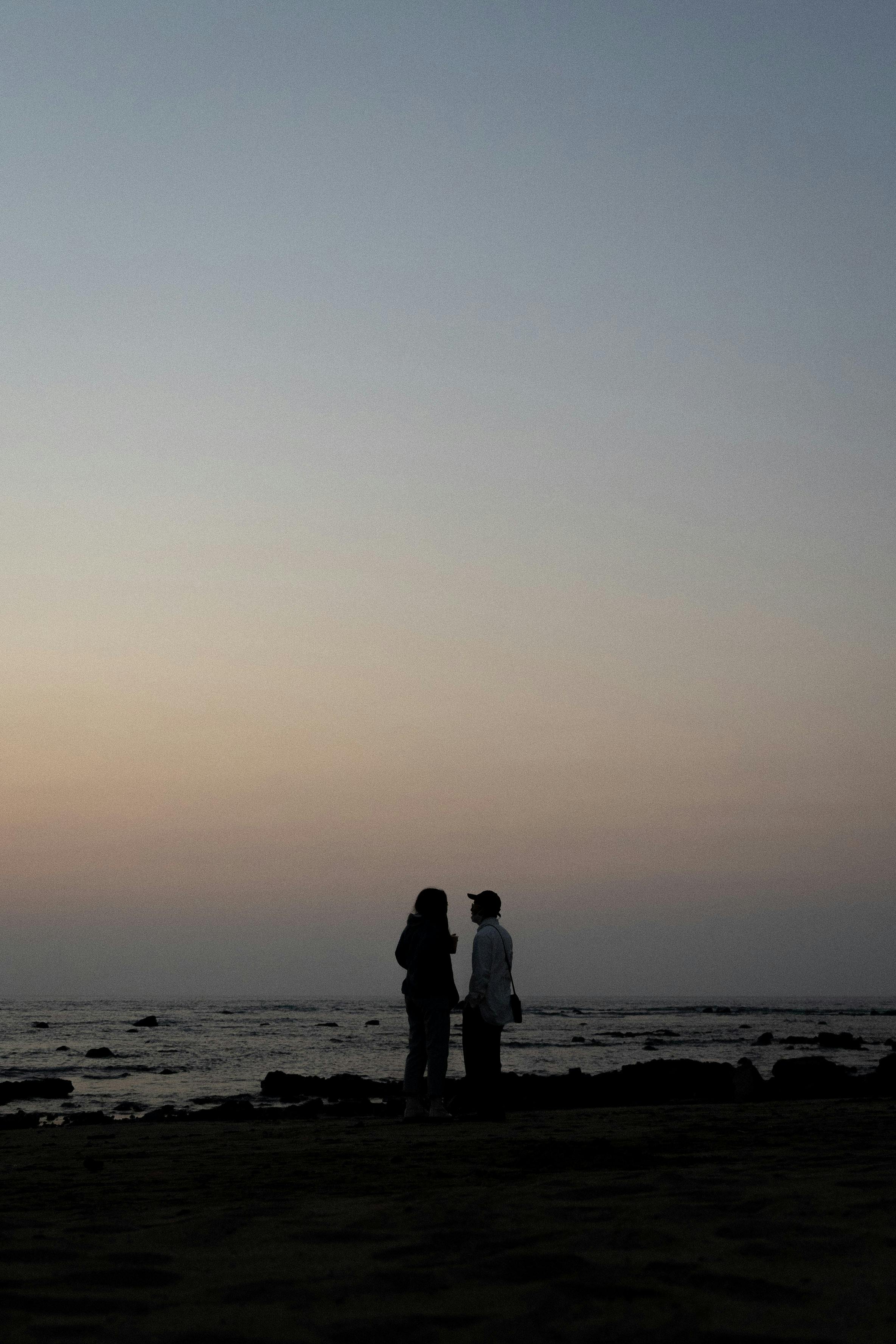 a couple standing on a beach