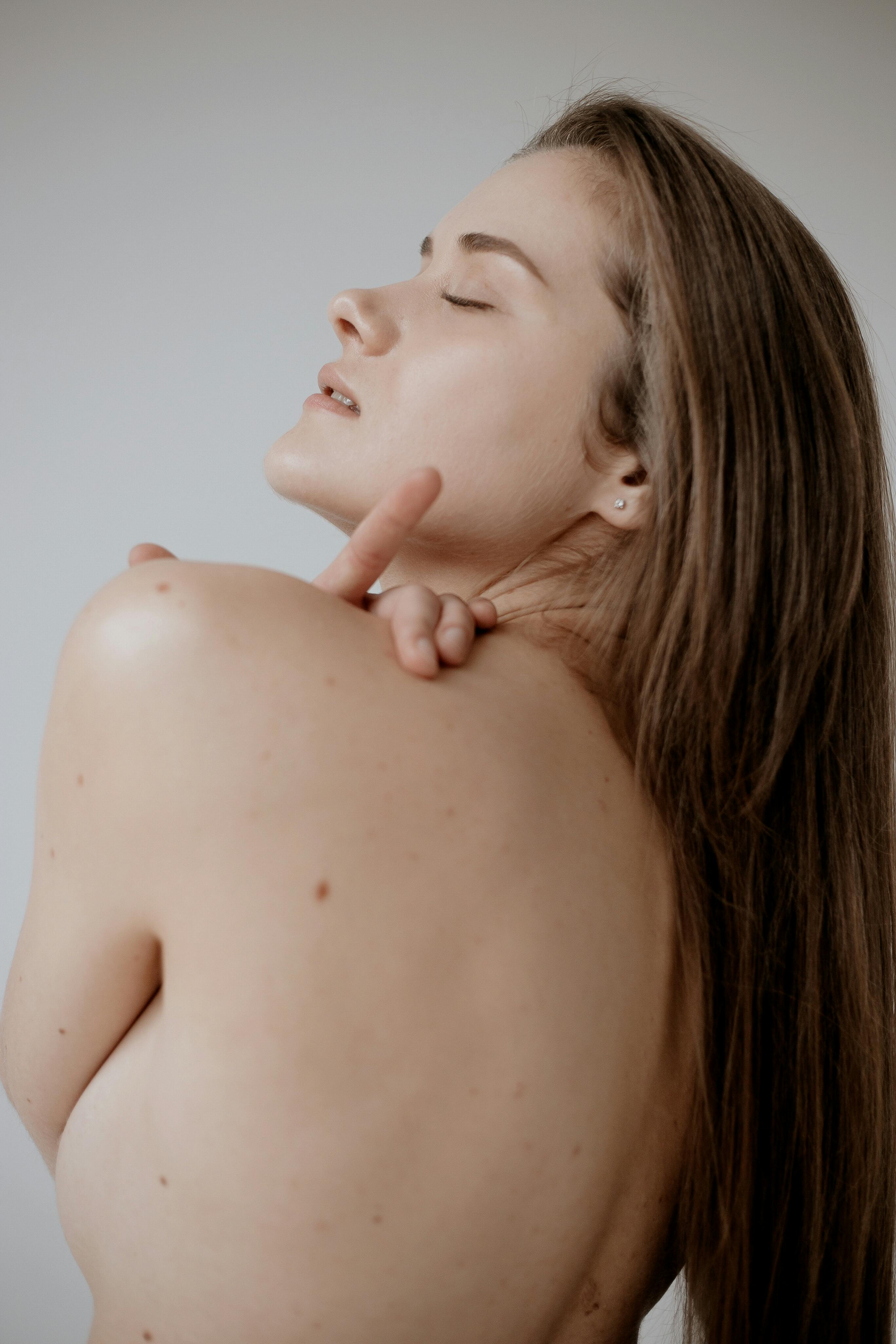 shoulder back and face of woman with eyes closed