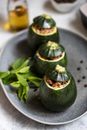 Eight-Ball Zucchinis Stuffed with Rice on Gray Ceramic Plate