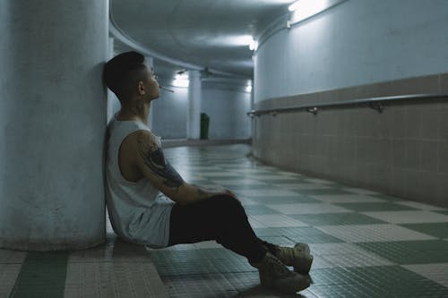 Young Man with a Cigarette Sitting in a Tunnel 