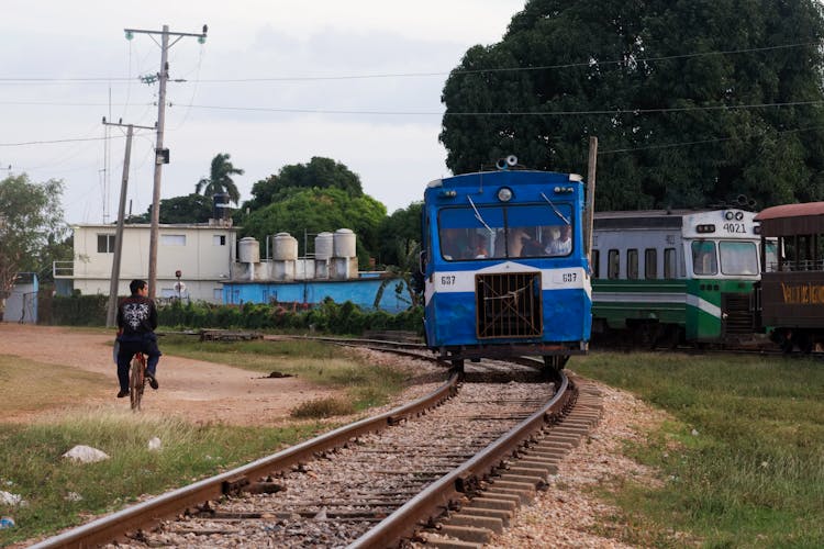 People Riding On Blue Train