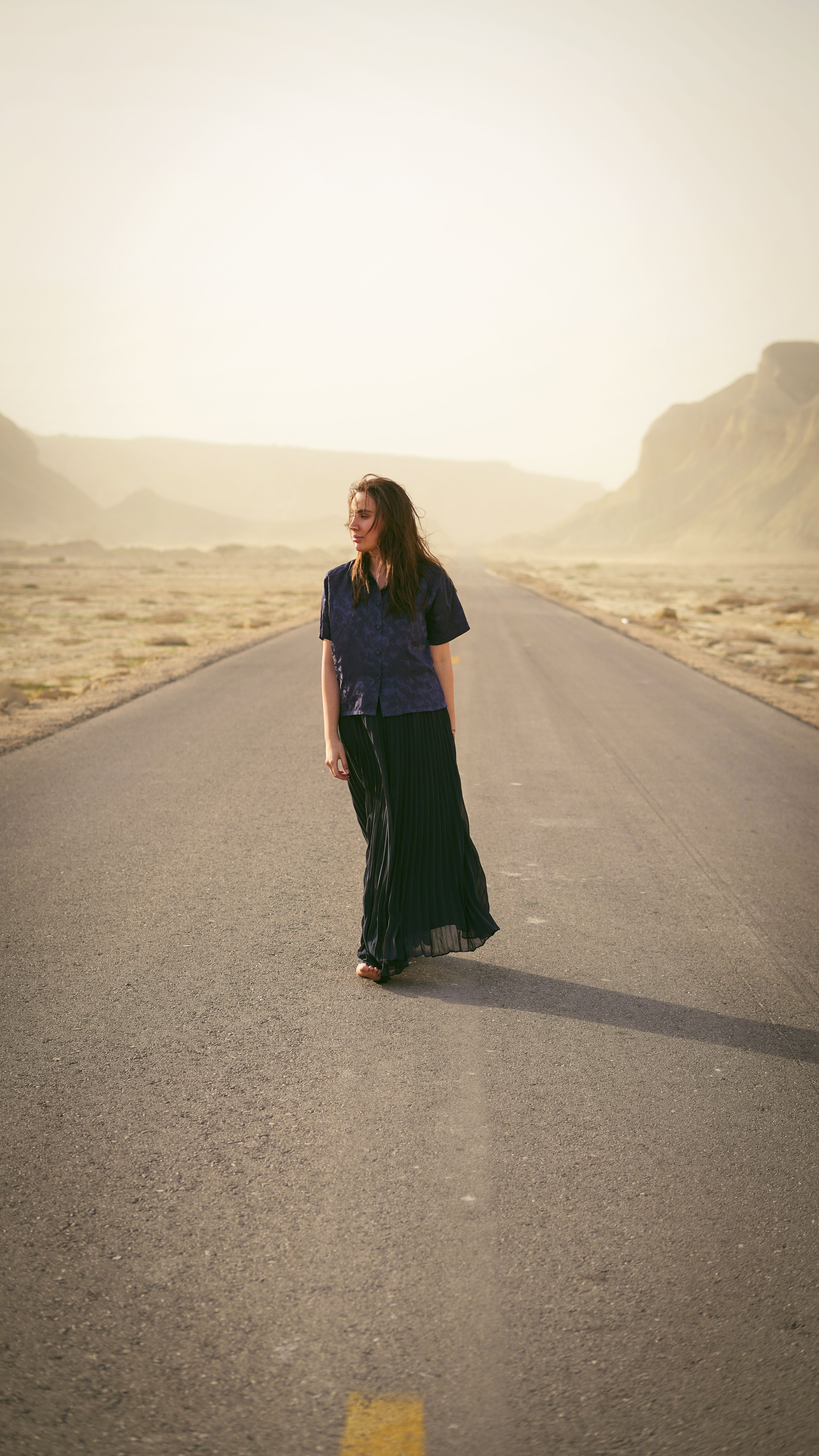 Woman in the Middle of Asphalt Road with Mountains Behind Her · Free ...