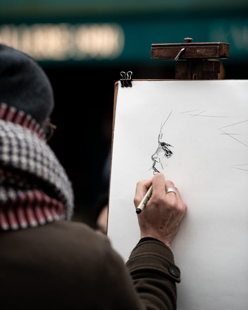 Person Drawing on White Paper