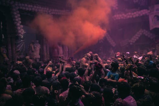 Lively Holi festival in Vrindavan, India, showcasing joyful crowd and colorful powder.