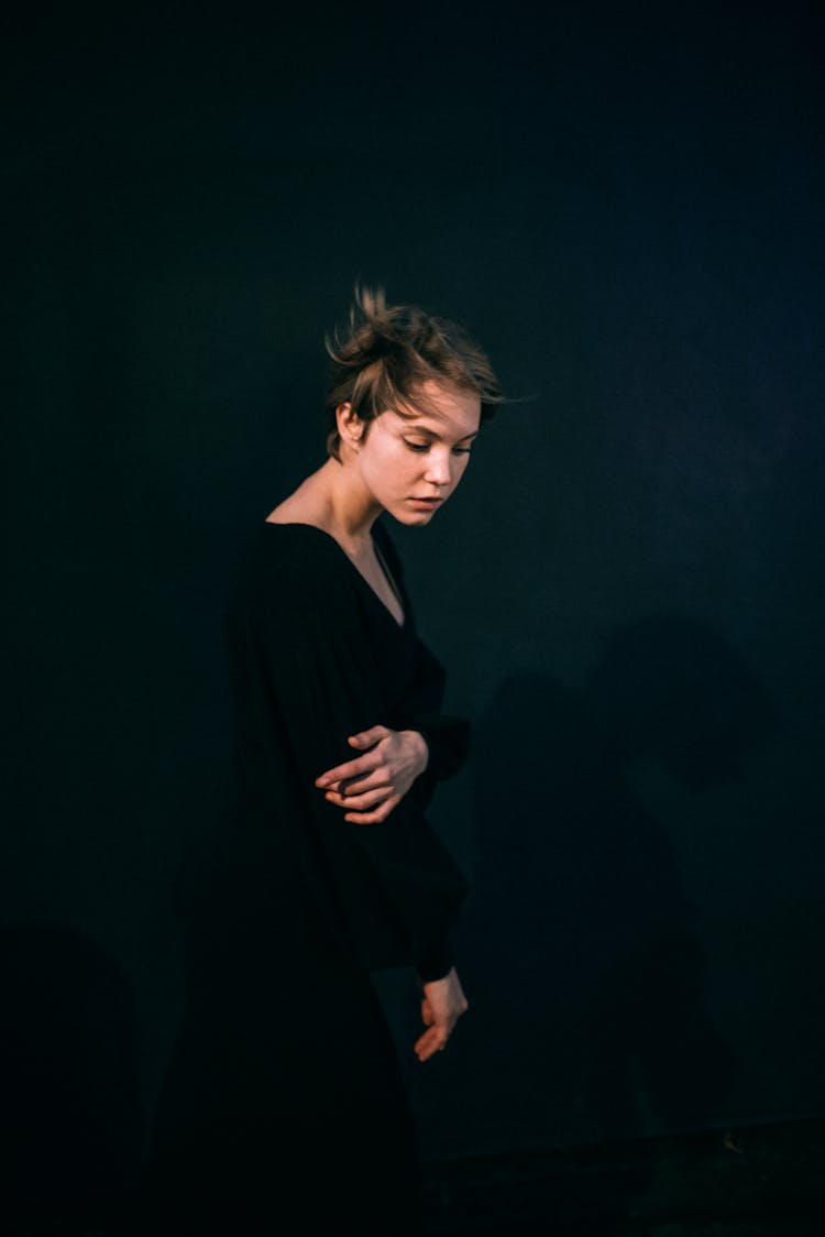 Woman Dressed In Black On Black Background