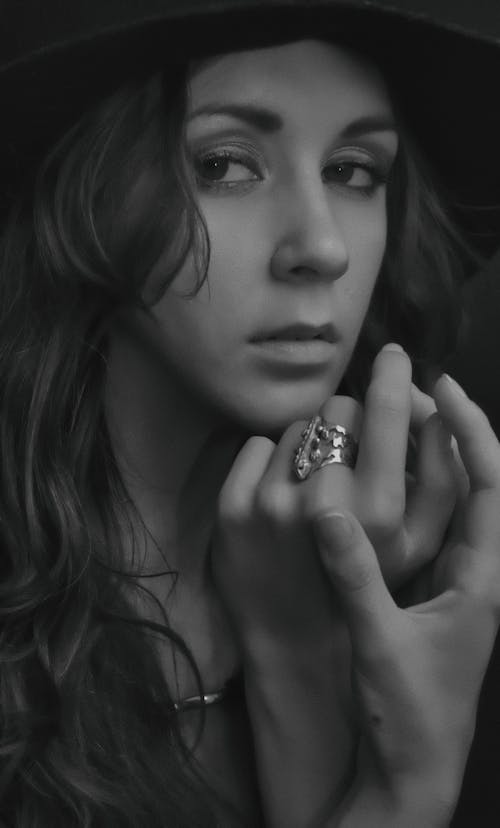 무료 날카로운 찾고 반지를 착용하는 여자의 회색조 사진 스톡 사진