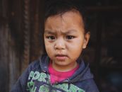 A Little Kid with Teary Eyed Looking at the Camera