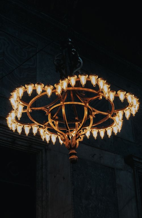 Free An ornate chandelier illuminates a dark, elegant room with warmth and sophistication. Stock Photo