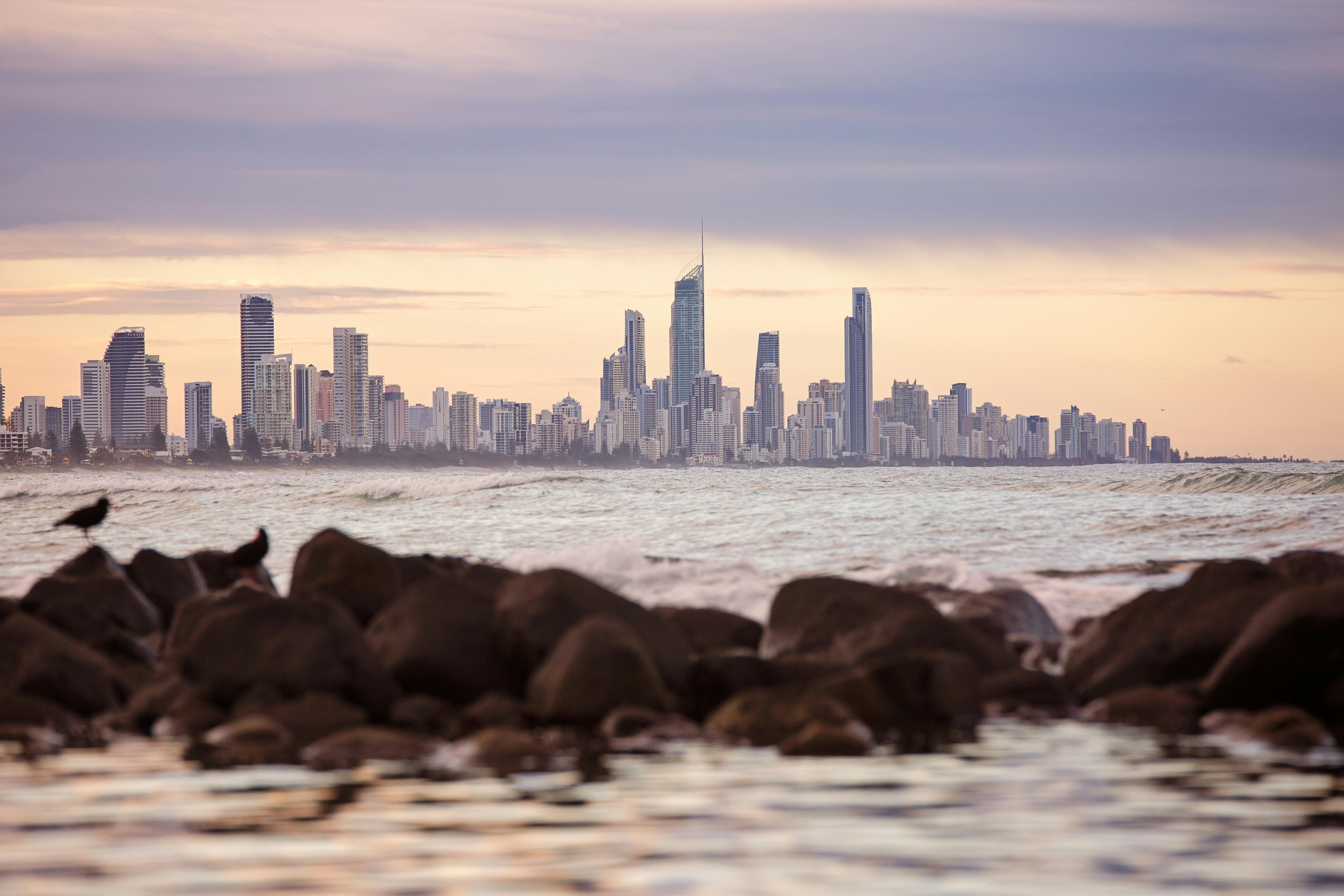 日落时分，从岩石海岸可以欣赏到冲浪者天堂天际线的迷人景色