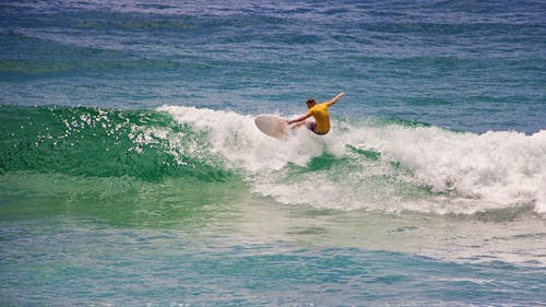 Man in Yellow Shirt Surfing