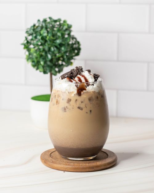 Free Delicious iced mocha topped with whipped cream and chocolate drizzle, perfect for indulgence. Stock Photo