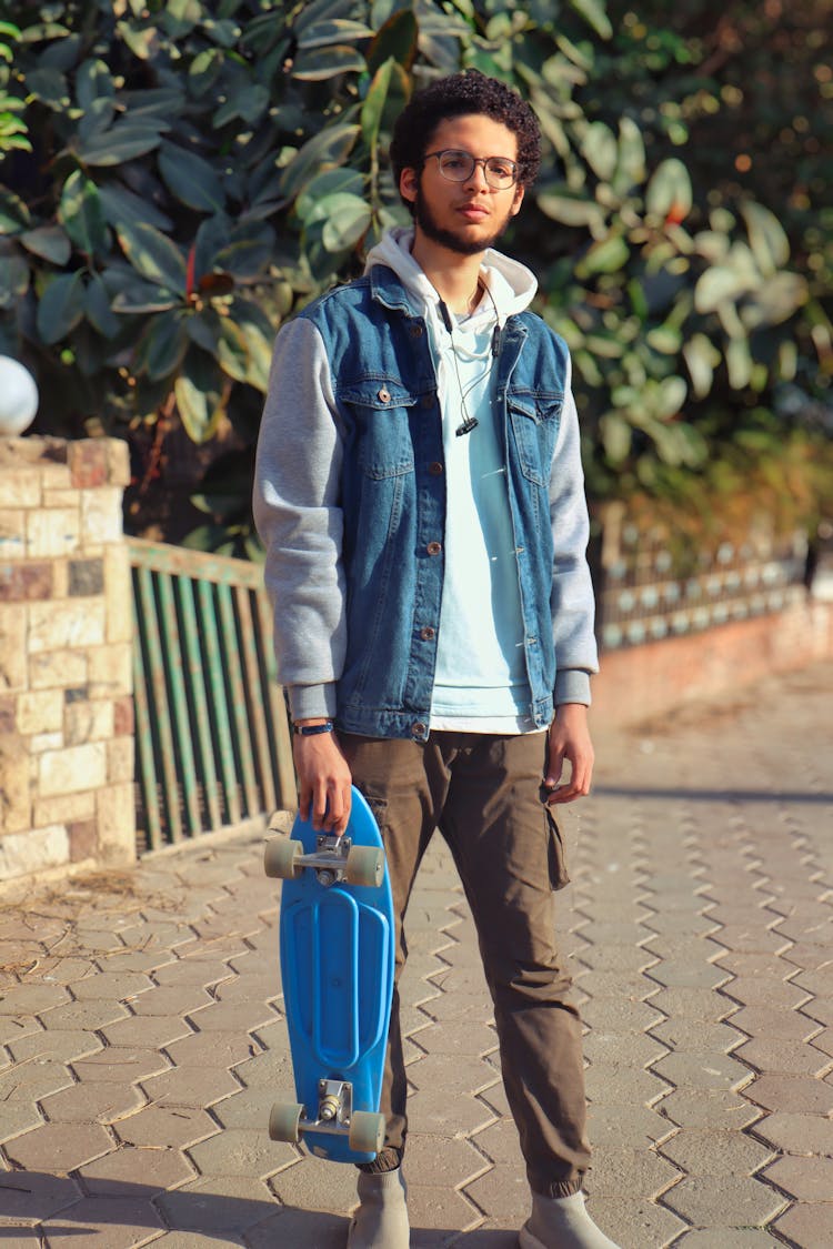 A Man Holding A Penny Board