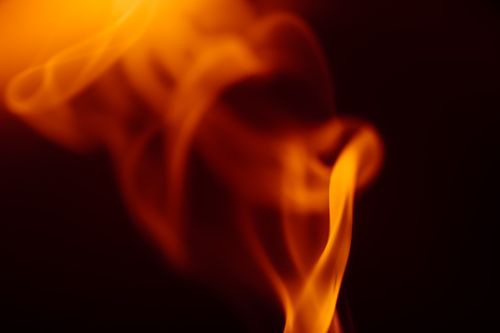Free Dynamic abstract flames captured against a dark background, exuding warmth and intensity. Stock Photo