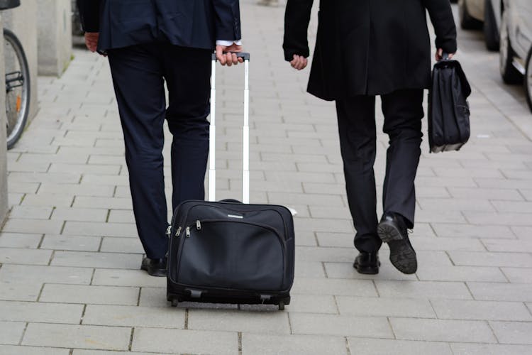 Businesspeople In Black Suits Walking In The Street 