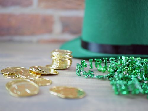 Free Close-up of gold coins and green beads with 'Irish' letters, perfect for St. Patrick's Day themes. Stock Photo