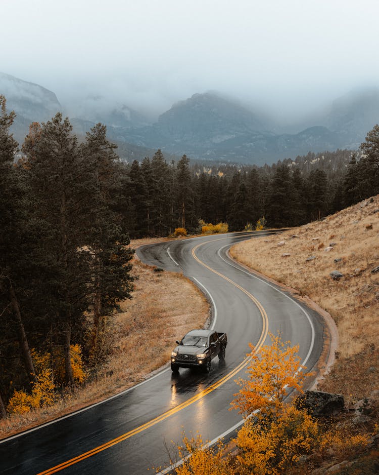 Car Driving Through Road In Mountains 