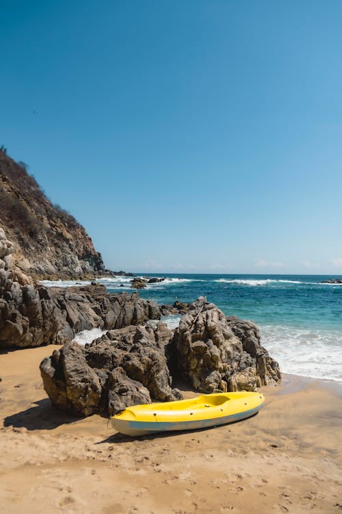 Kayak next to Rocks on Beach