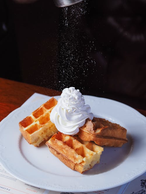 Delicious Waffles Topped with Whipped Cream on White Plate