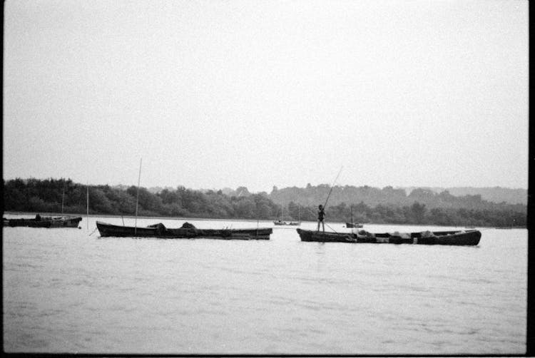 Person Fishing On Boat In Water