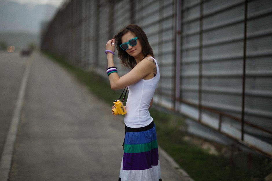 People walking on a sunny street in Belgrade, Serbia, dressed in light summer clothing