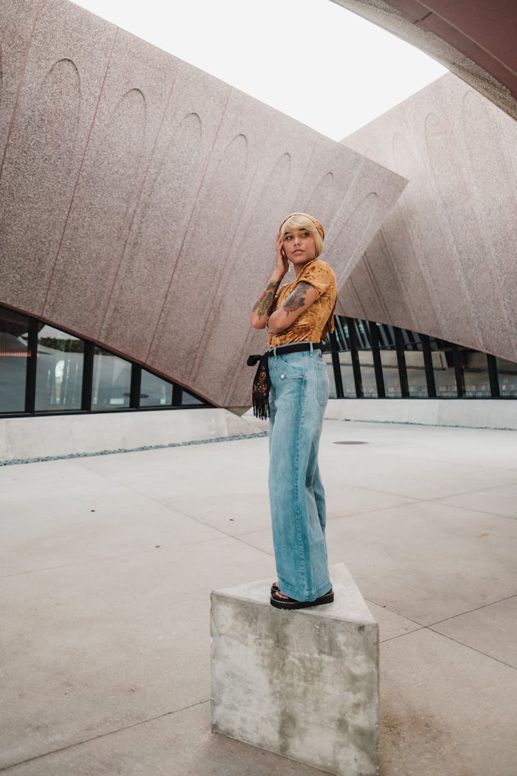 Woman Standing On Concrete Block In Empty Room