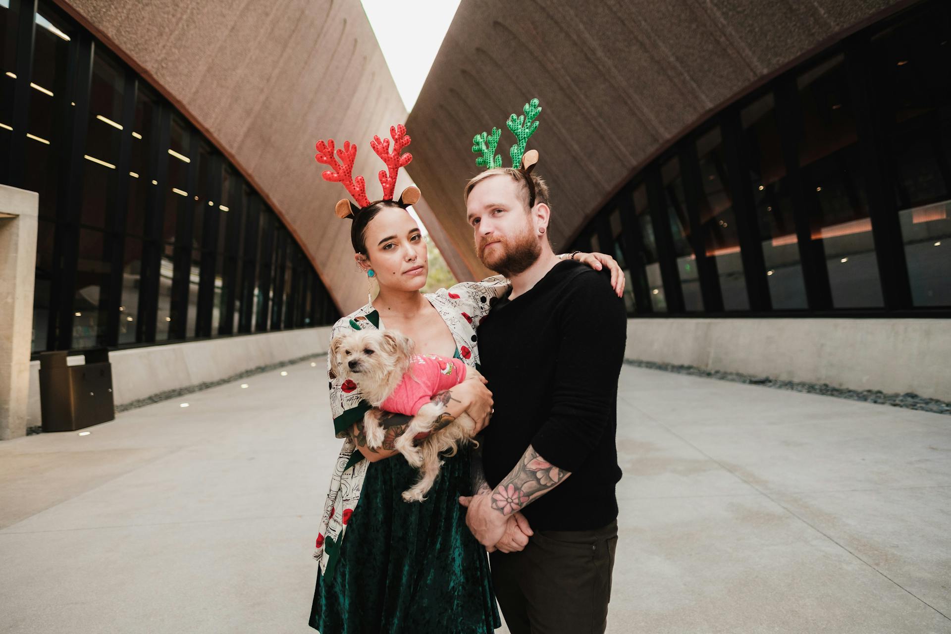 Couple with a Dog Wearing Reindeer Headbands