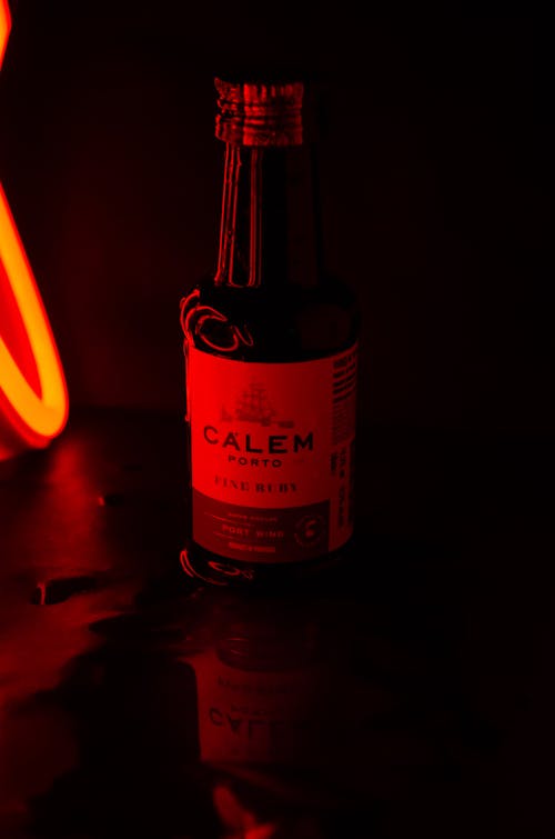 A Bottle of Wine Illuminated by a Red Light
