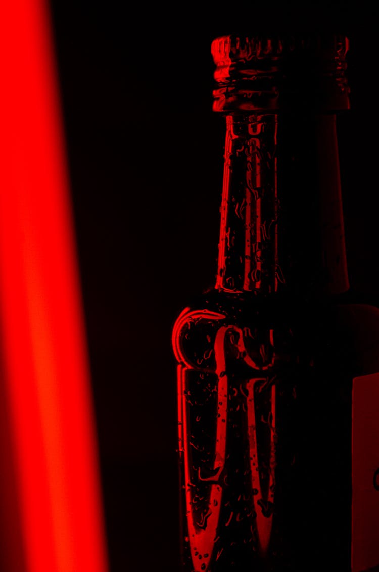 A Close-up Shot Of A Glass Bottle With Water Droplets