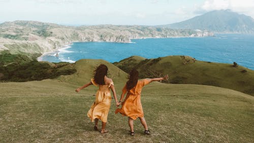 Women Holding Hands And Looking at View 