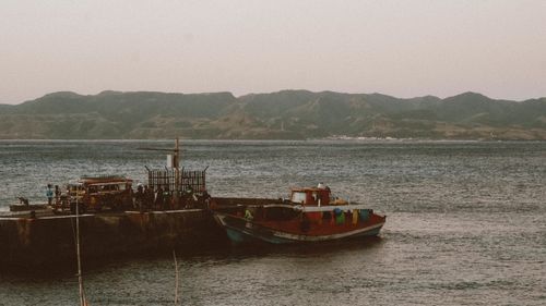 Free Peaceful dock scene with a fishing boat and mountains in Cagayan Valley, Philippines. Stock Photo