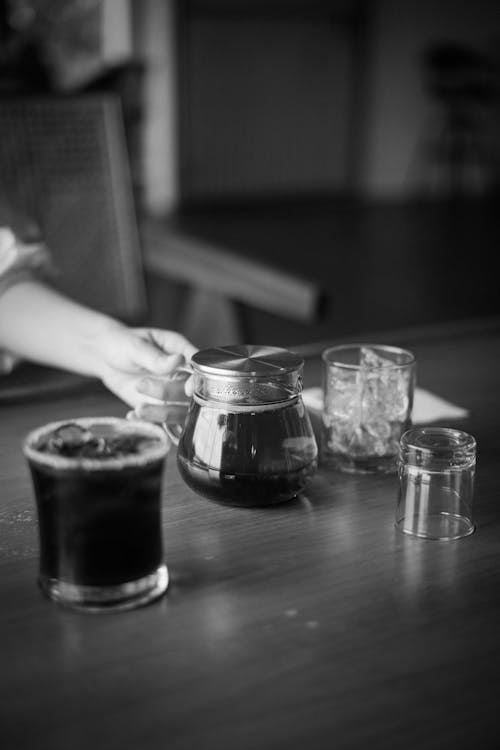 Free Grayscale Photo of 2 Clear Glass Mugs on Table Stock Photo