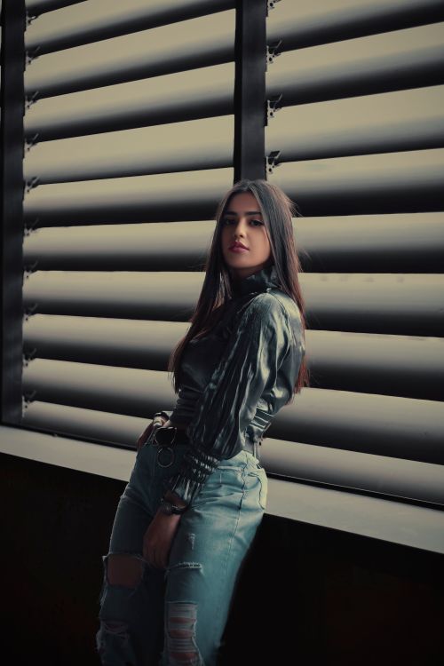 Woman in Black Leather Jacket and Blue Denim Jeans Standing Beside ...