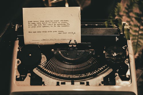 White Typewriter With Paper Inserted