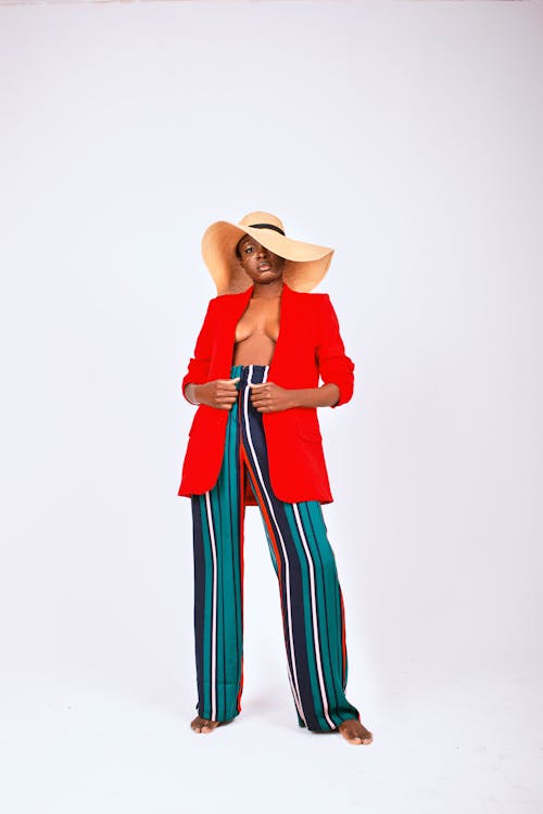 Woman Posing Shirtless in Jacket and Wide Hat