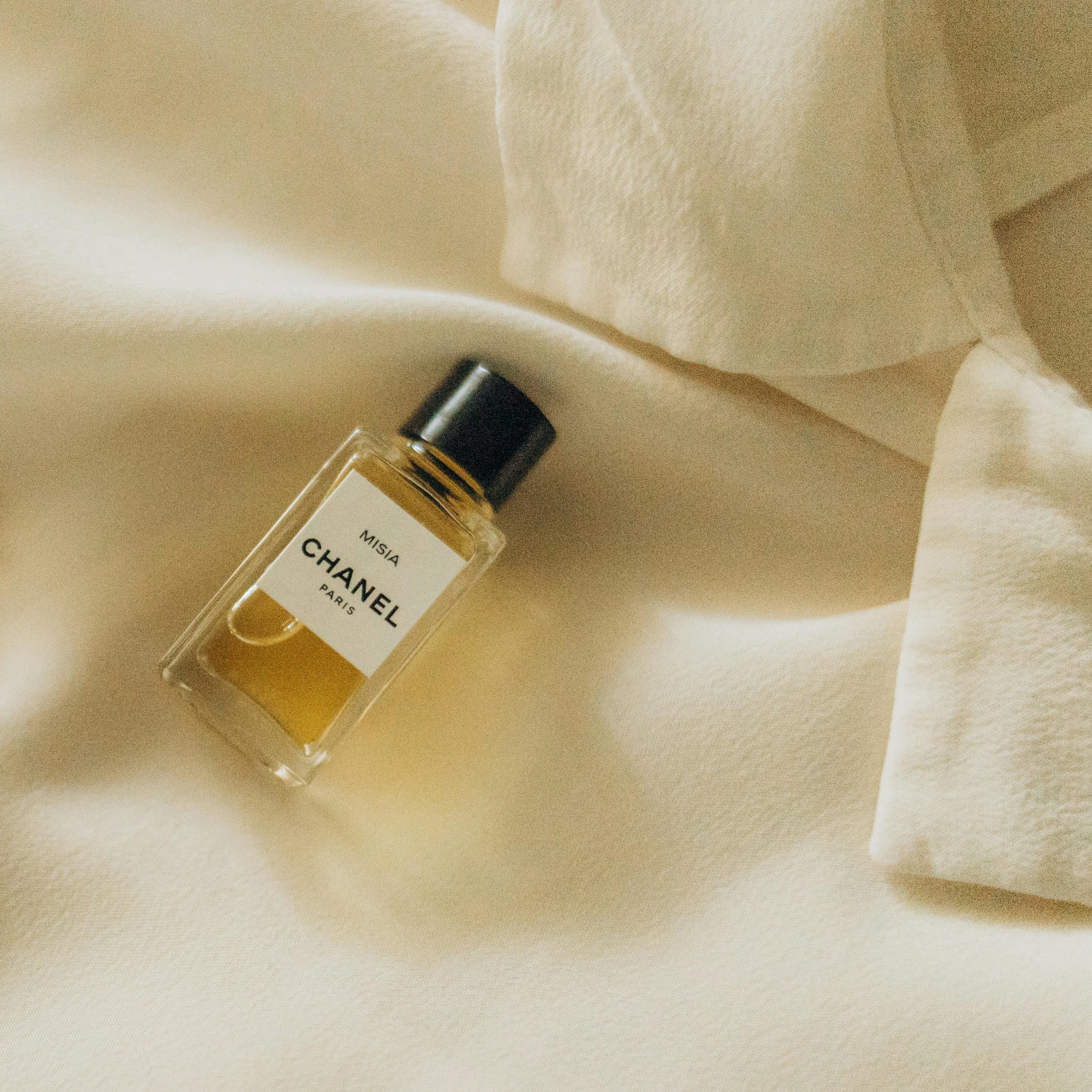 Perfume Bottle Lying on Fleece Blouse
