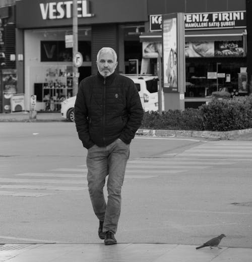 Grayscale Photo of a Man Walking