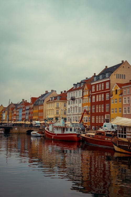 Boats Moored near Colorful Houses in Nyhavn Harbor, Copenhagen, Denmark