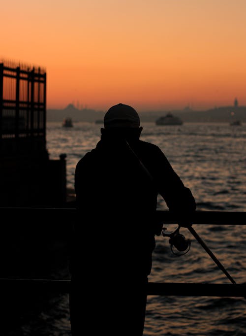 Silhouette of a Person Fishing