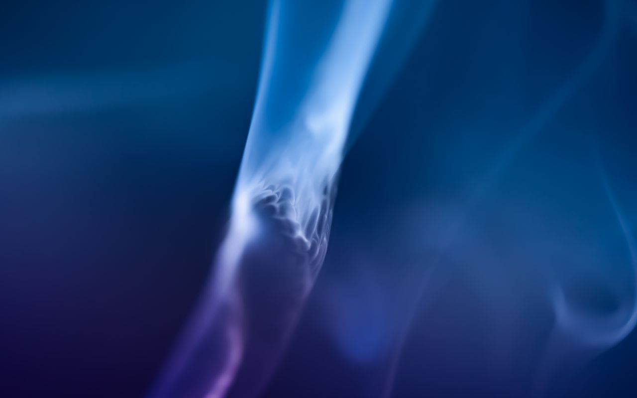 a captivating abstract image of blue smoke swirling gracefully against