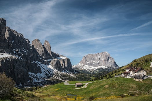 Breathtaking view of the Dolomites with scattered houses and lush greenery in Trentino-South Tyrol, Italy.
