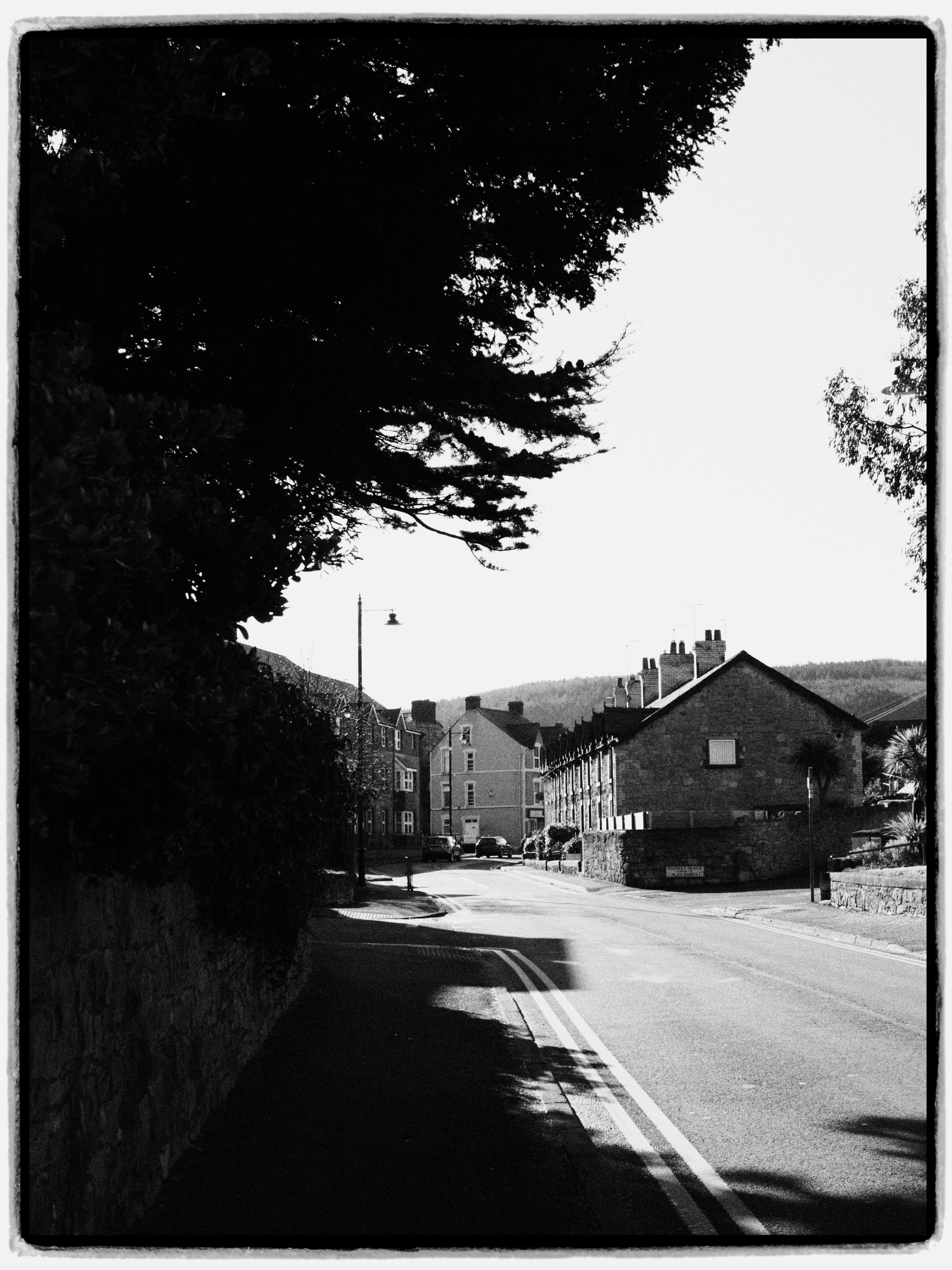 A picturesque black and white view of a quaint street in Abergele, Wales, highlighting its unique charm.