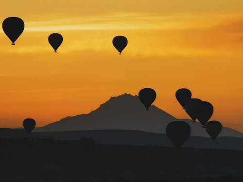 Základová fotografie zdarma na téma hora, horkovzdušné balóny, oranžová obloha