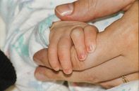 Persons Hand on White and Blue Textile
