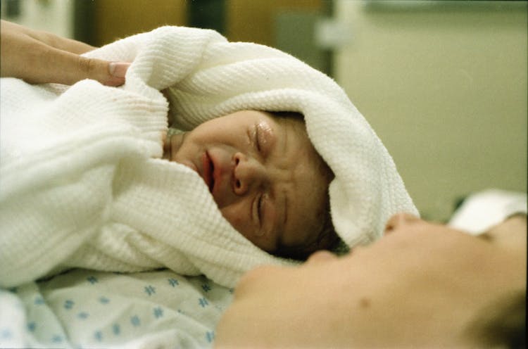 Baby Wrapped In White Blanket