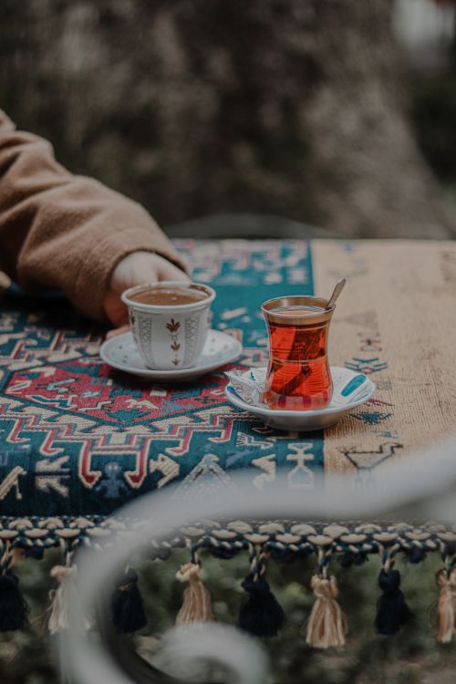 Free Close-up of Turkish tea and coffee cups on a colorful tablecloth outdoors. Stock Photo