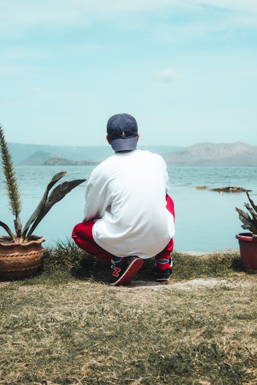 Back View of a Person with a Cap Crouching