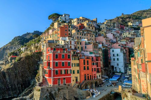 Free Stunning view of colorful houses perched on a cliff in Riomaggiore, Liguria, showcasing Italian charm. Stock Photo