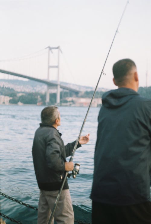 35mm film, adam, Balık tutmak içeren Ücretsiz stok fotoğraf